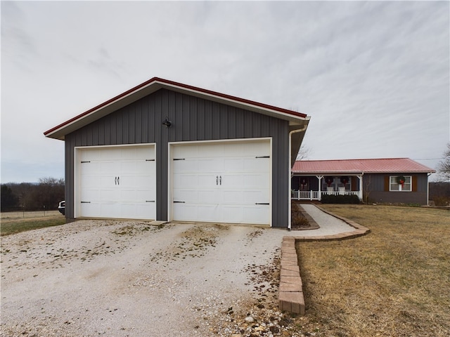 detached garage featuring covered porch