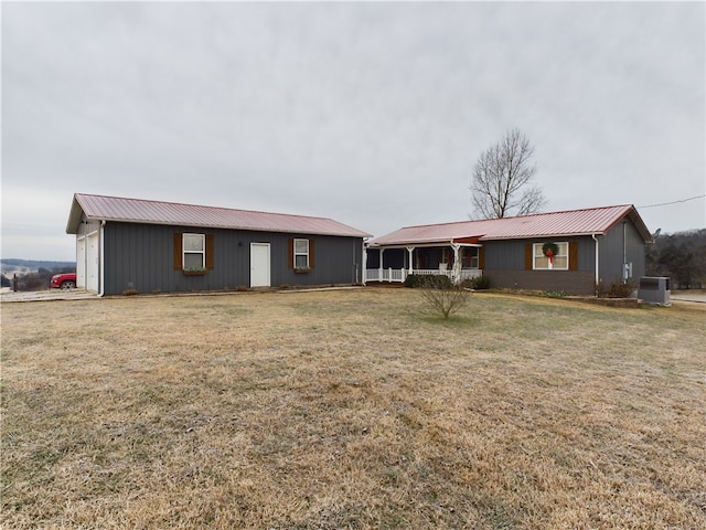 ranch-style home with a front lawn, a porch, and central AC