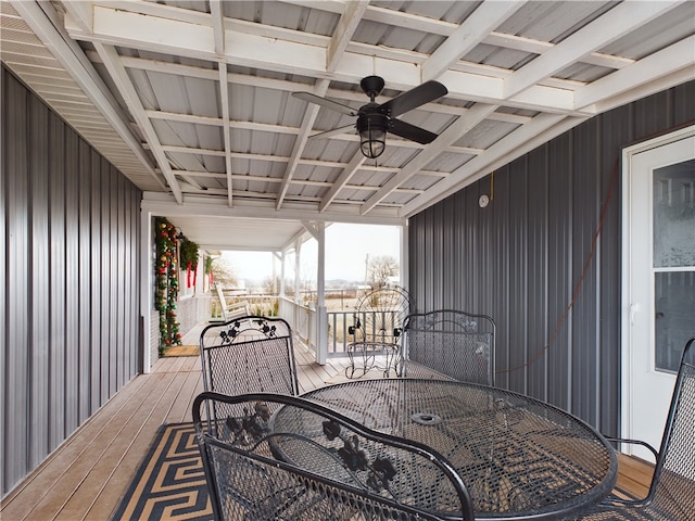 wooden terrace with outdoor dining space and ceiling fan