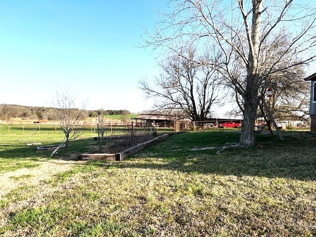 view of yard with a rural view