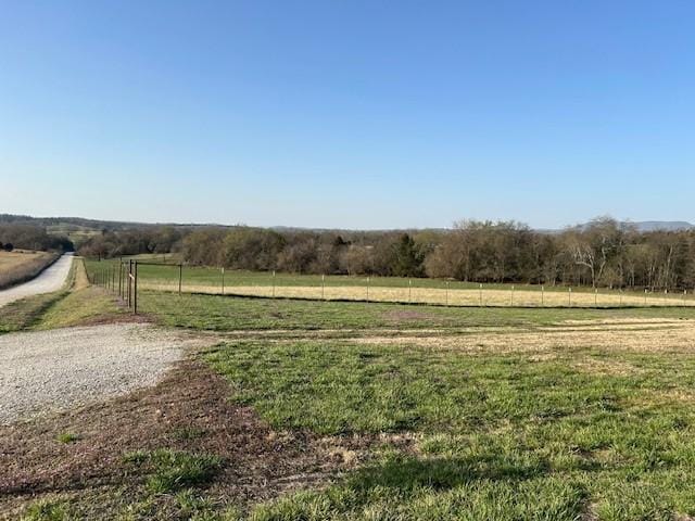 view of yard featuring a rural view and fence