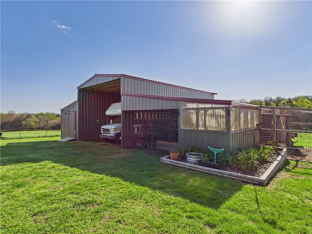 view of pole building featuring a yard and fence