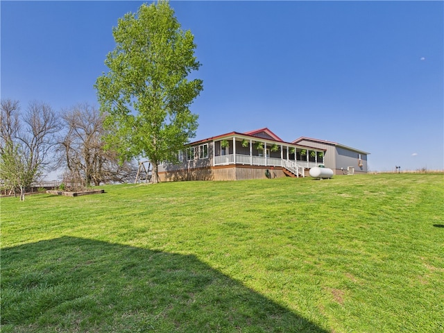 view of yard with a sunroom