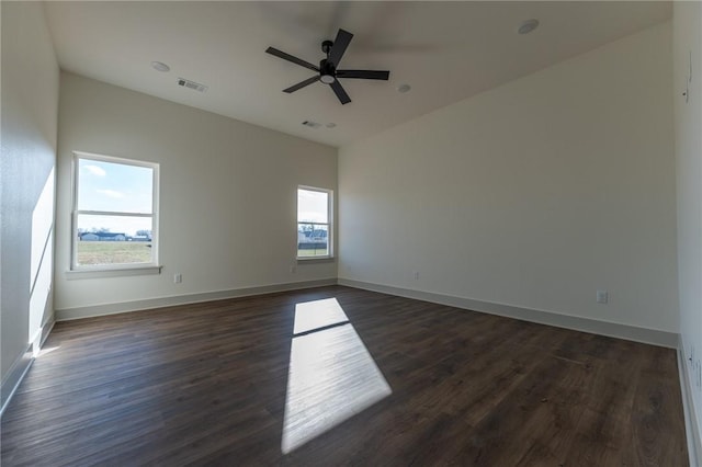 empty room with dark hardwood / wood-style flooring and ceiling fan