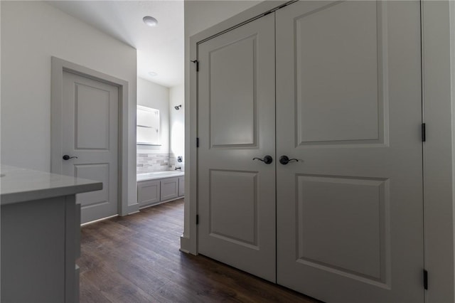 hallway with dark wood-type flooring