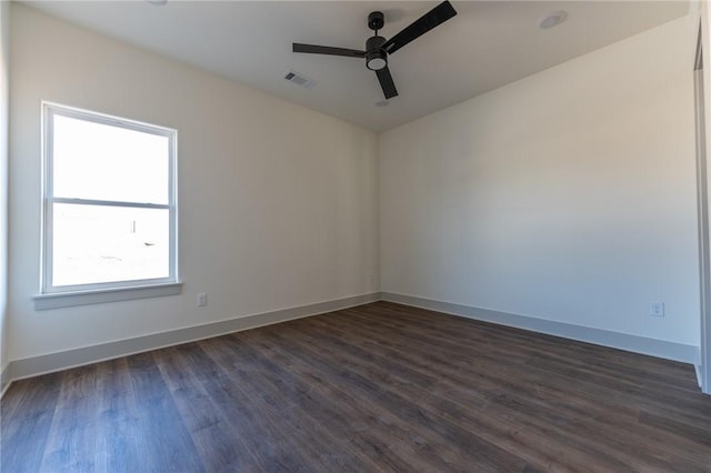 spare room with ceiling fan and dark hardwood / wood-style flooring