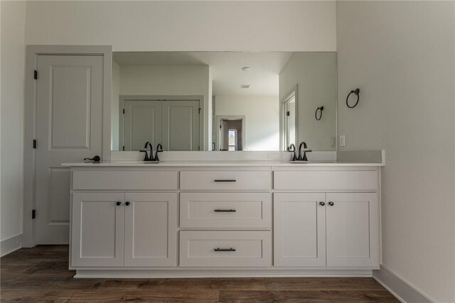 13121 Bethel Blacktop Rd, Farmington, AR 72730 - full bathroom featuring double vanity, wood finished floors, baseboards, and a sink