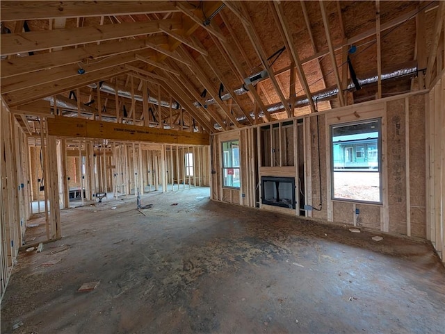 unfurnished living room with vaulted ceiling