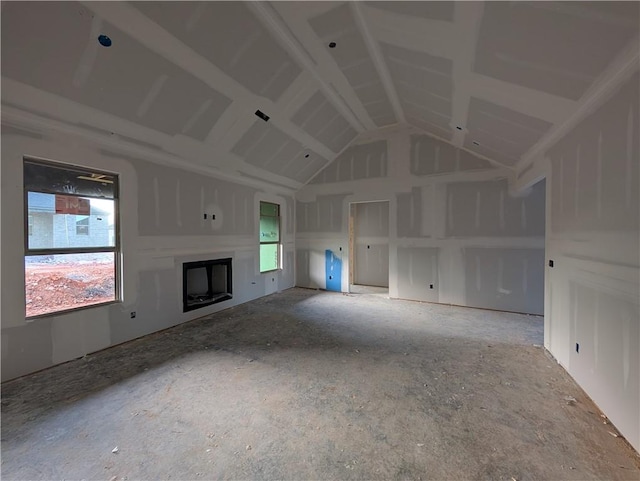 unfurnished living room featuring a fireplace and high vaulted ceiling