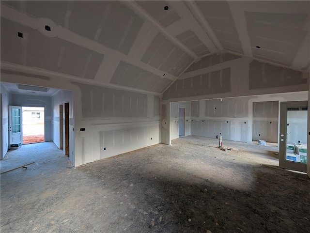 unfurnished living room with lofted ceiling