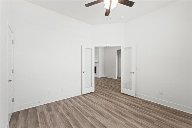 spare room featuring hardwood / wood-style flooring and ceiling fan