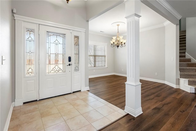 entryway with a healthy amount of sunlight, ornate columns, crown molding, and light tile patterned flooring