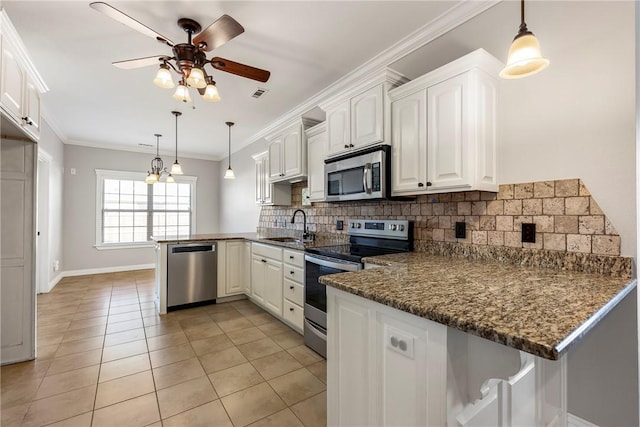 kitchen featuring kitchen peninsula, crown molding, white cabinets, and stainless steel appliances