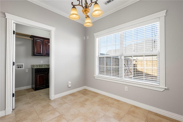 unfurnished dining area with ornamental molding and an inviting chandelier