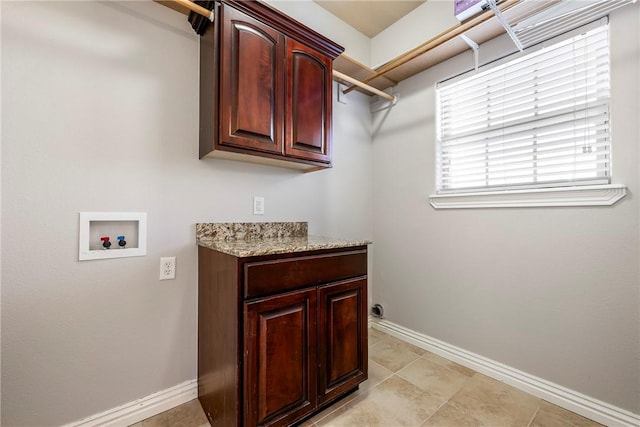 clothes washing area with hookup for a washing machine and cabinets