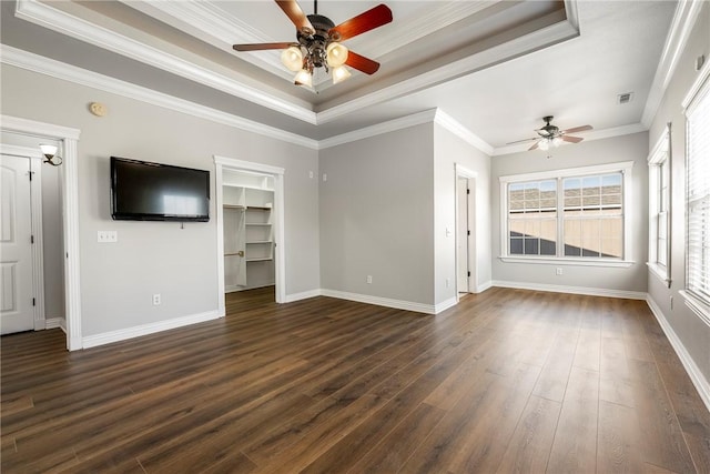 unfurnished living room with a tray ceiling, ceiling fan, ornamental molding, and dark hardwood / wood-style floors