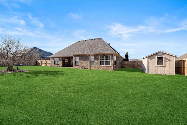 back of house with a mountain view, a storage shed, and a lawn