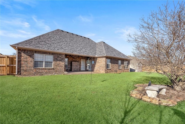 rear view of property featuring a lawn and a patio area