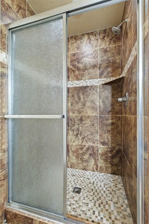 bathroom with a shower with door