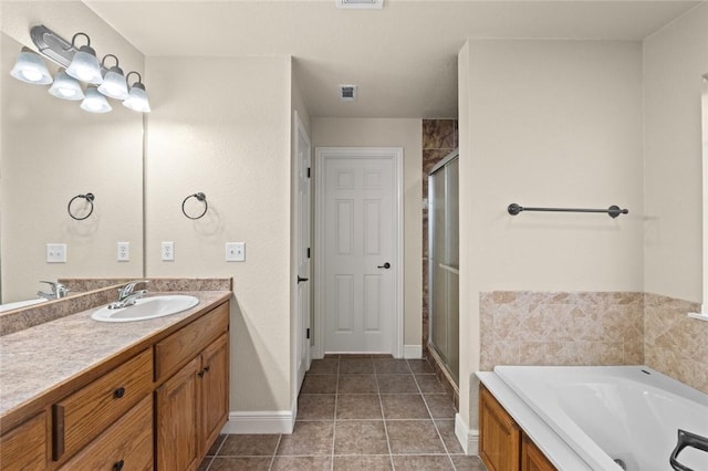 bathroom featuring tile patterned floors, vanity, and separate shower and tub