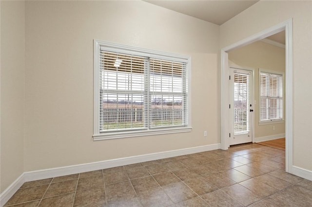 unfurnished room with light tile patterned floors and ornamental molding