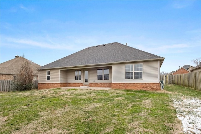 rear view of property with a yard