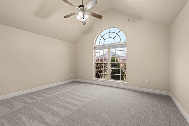 carpeted spare room featuring ceiling fan and lofted ceiling