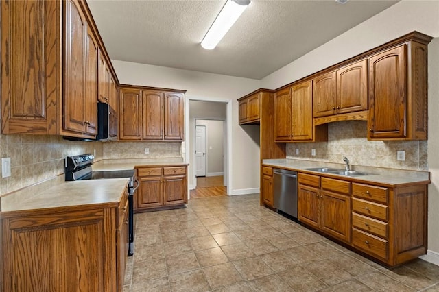 kitchen with a textured ceiling, sink, appliances with stainless steel finishes, and tasteful backsplash