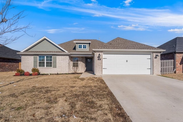 view of front of home featuring a garage and a front lawn