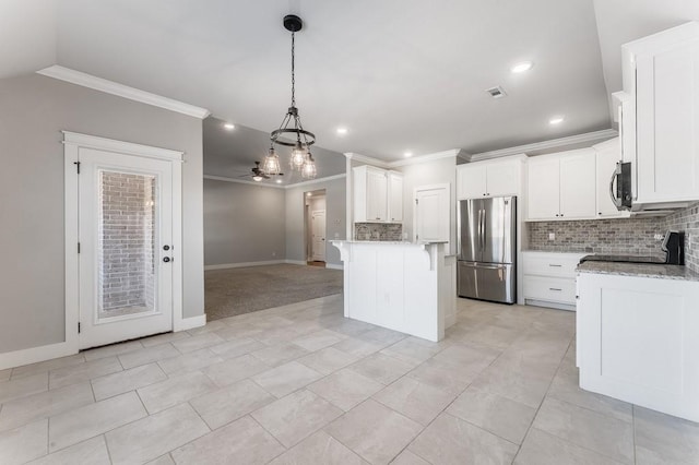 kitchen featuring light stone counters, white cabinets, appliances with stainless steel finishes, and ceiling fan