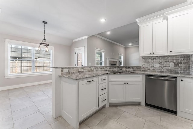 kitchen with light stone countertops, decorative backsplash, sink, white cabinetry, and stainless steel dishwasher