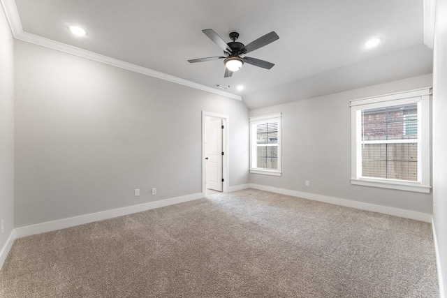 unfurnished room with vaulted ceiling, ornamental molding, ceiling fan, and carpet