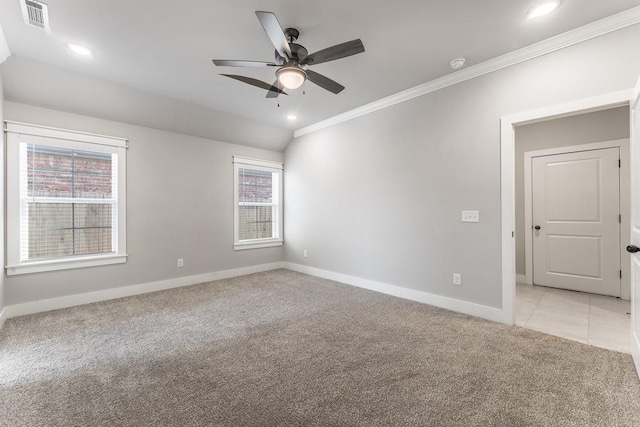 spare room featuring light colored carpet, ceiling fan, crown molding, and a wealth of natural light