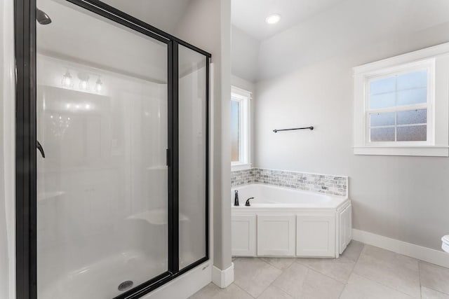 bathroom featuring tile patterned floors, plenty of natural light, and separate shower and tub