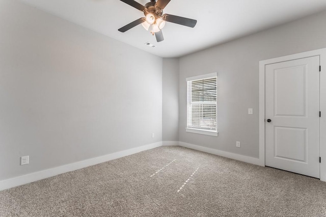 spare room featuring carpet flooring and ceiling fan