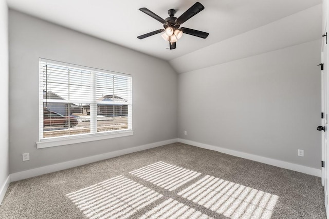 empty room with carpet floors, ceiling fan, and vaulted ceiling