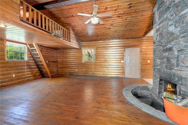 living room with a stone fireplace, wood ceiling, hardwood / wood-style flooring, ceiling fan, and log walls