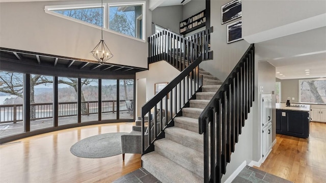 stairway with a chandelier