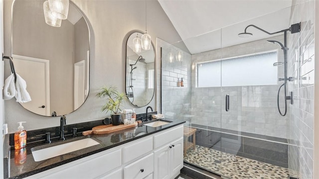 bathroom with vanity, a shower with door, and lofted ceiling