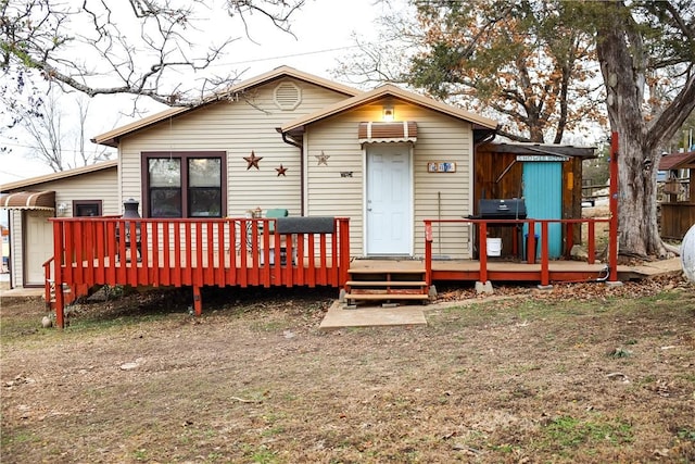 back of property featuring a wooden deck