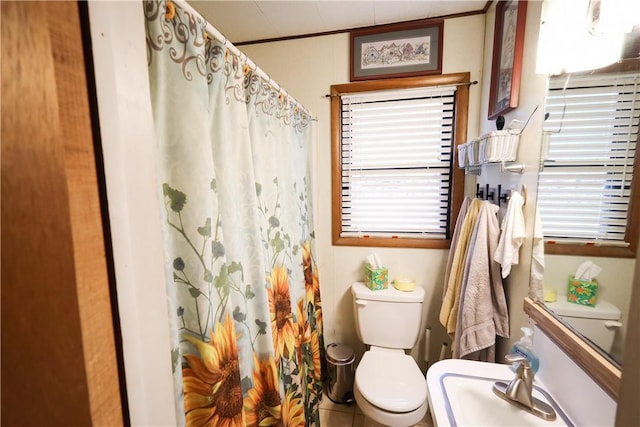 bathroom with toilet, tile patterned flooring, and crown molding