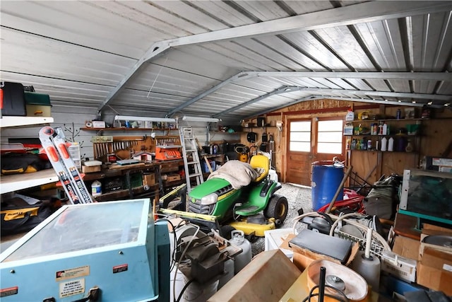 garage featuring wooden walls and a workshop area