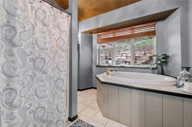 full bathroom featuring baseboards, a bath, and tile patterned floors