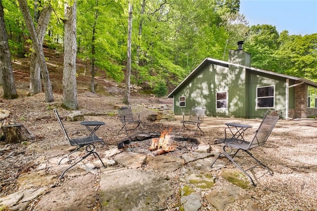 exterior space featuring a fire pit and a chimney