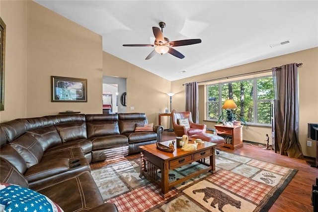 living room featuring lofted ceiling, visible vents, ceiling fan, and wood finished floors