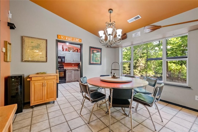 dining area with beverage cooler, visible vents, vaulted ceiling, and light tile patterned floors