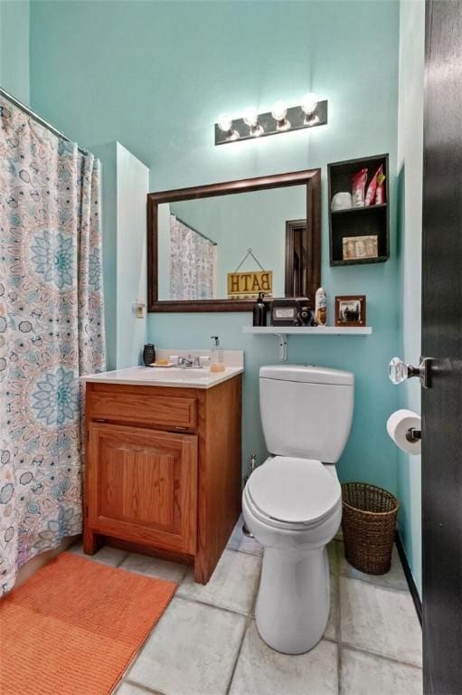 full bath featuring a shower with curtain, vanity, toilet, and tile patterned floors