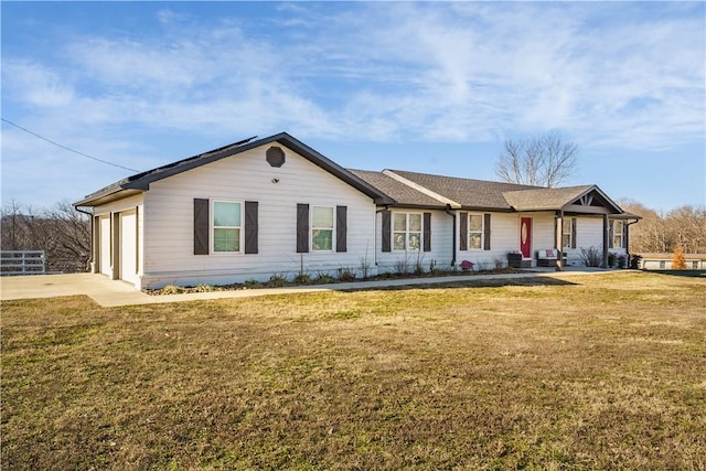 ranch-style home featuring a garage and a front yard