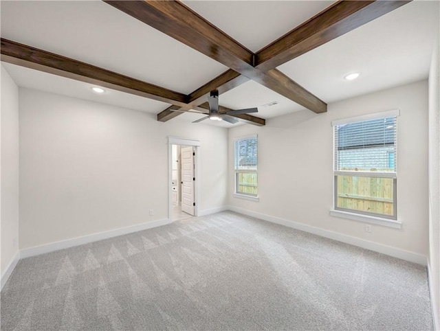 carpeted empty room with coffered ceiling, beamed ceiling, and ceiling fan