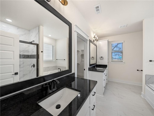 bathroom with separate shower and tub, vanity, and a wealth of natural light